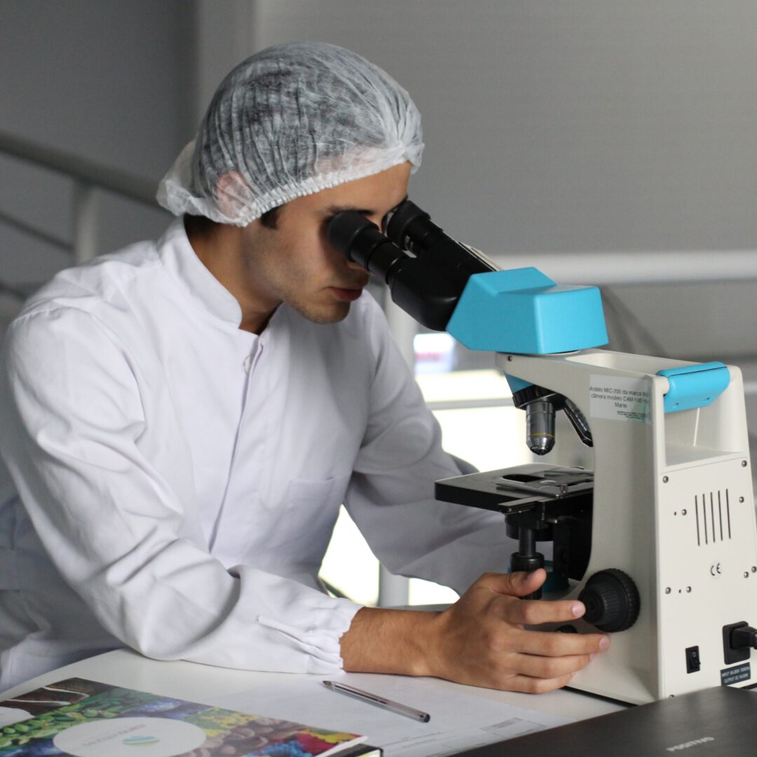 A researcher using a microscope